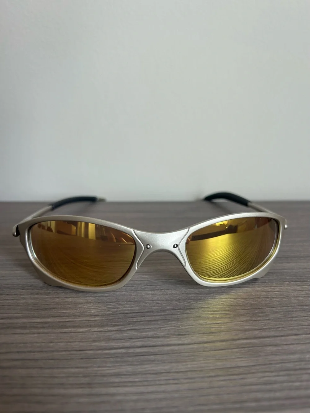 Oakley Silver Frame Sunglasses with Gold Mirrored Lenses